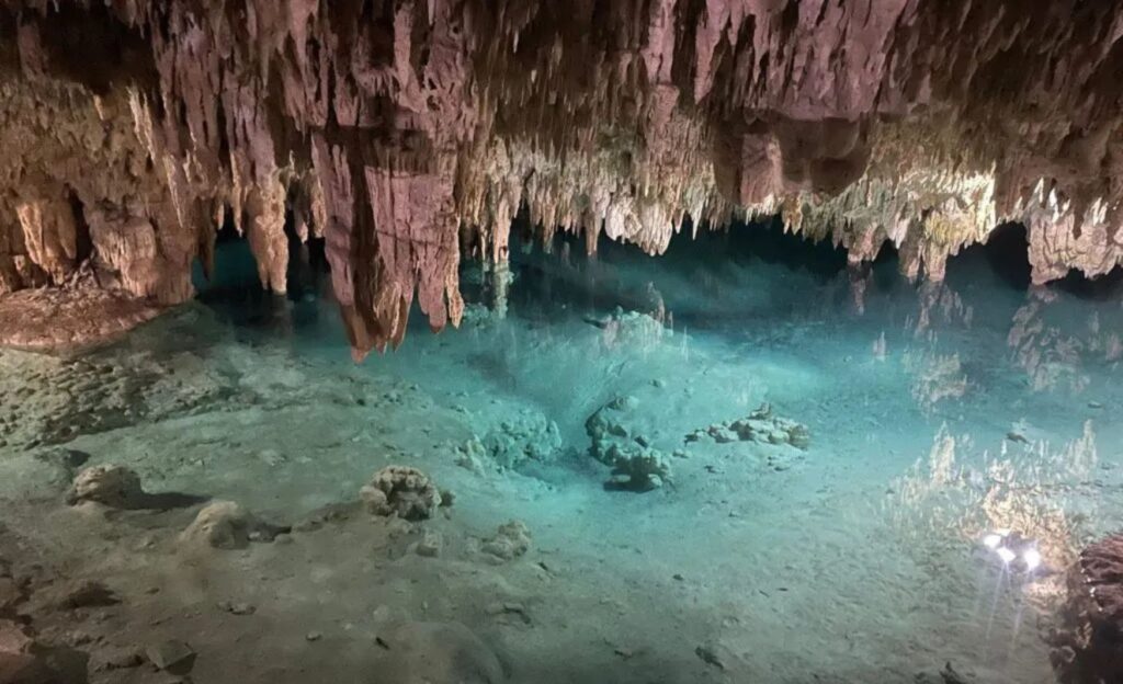 Cave system with clear waters and stalactites