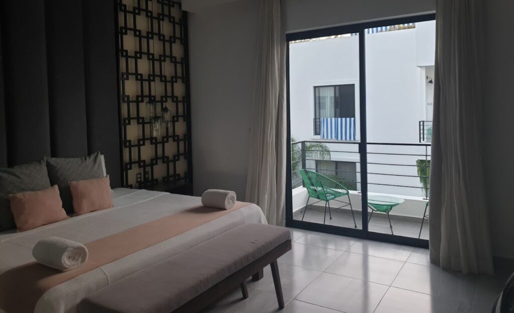 Modern room featuring a cozy white bed and sleek gray accents.